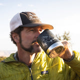 Close up of a man drinking from a klean kanteen eco-friendly metal camp mug in the black mountain colour