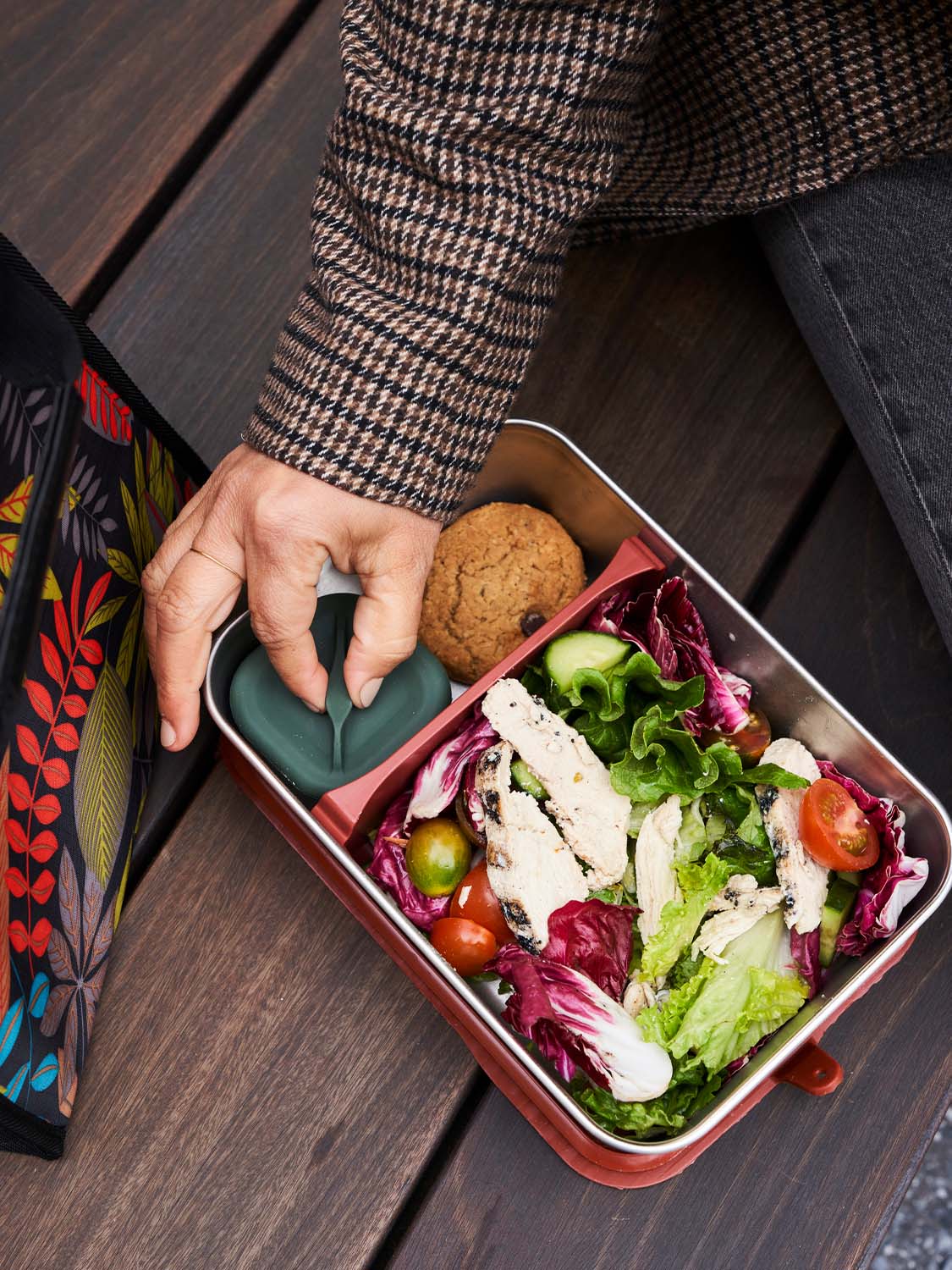 Person wearing a tweed jacket removing the Klean Kanteen Rise Stainless Steel Half Snack Box from a Big Meal Box (available separately from Babipur) filled with a delicious salad