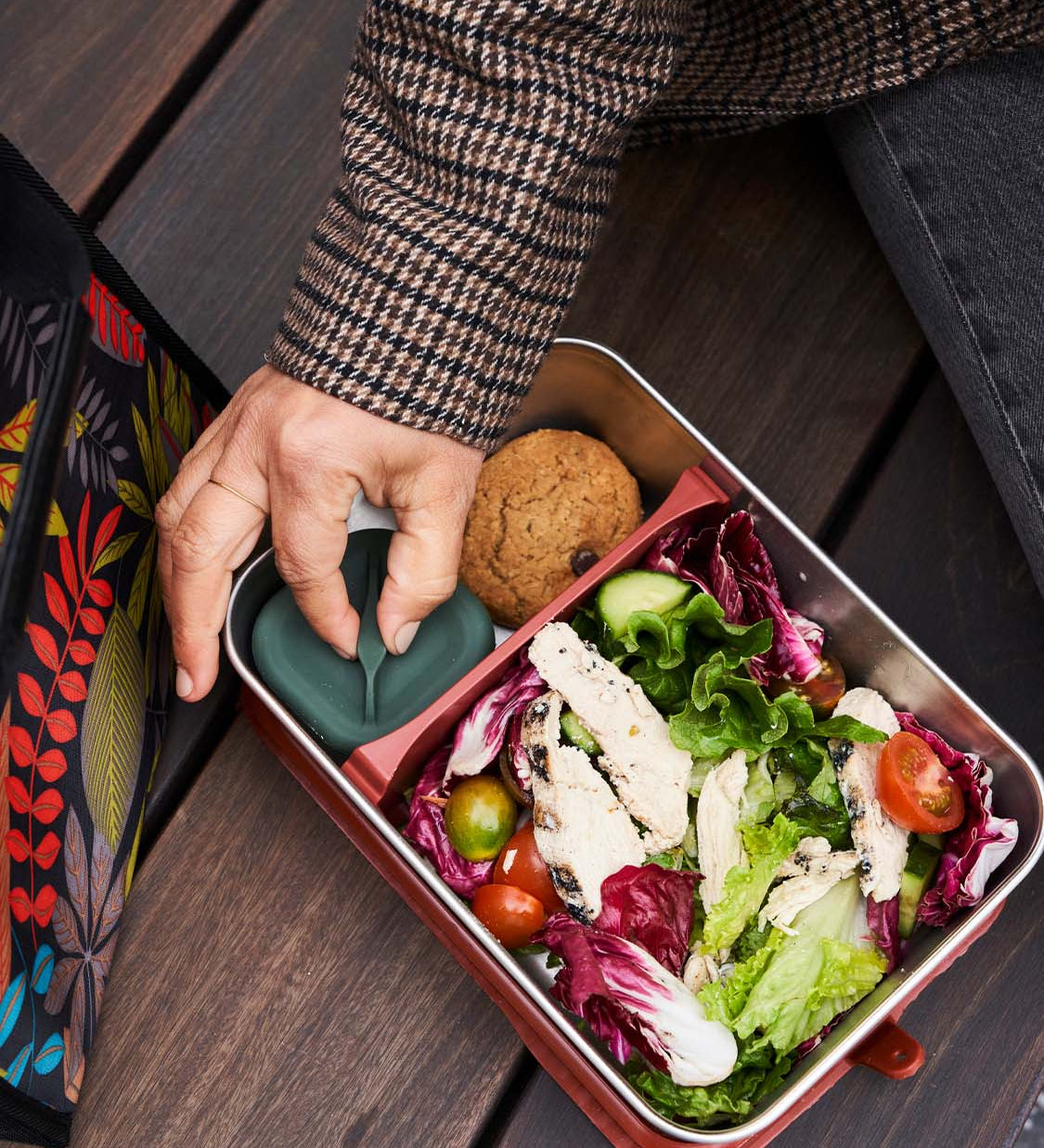 Person wearing a tweed jacket having lunch from the Klean Kanteen Rise Stainless Steel Big Meal Box with divider