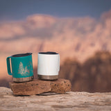 Close up of 2 Klean kanteen eco-friendly metal travel mugs balanced on a rock 