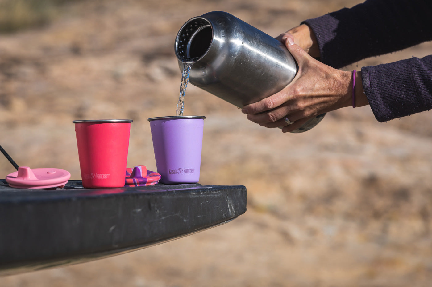 Close up of a child drinking from the Klean Kanteen reusable stainless steel straw cup in the green and blue colour