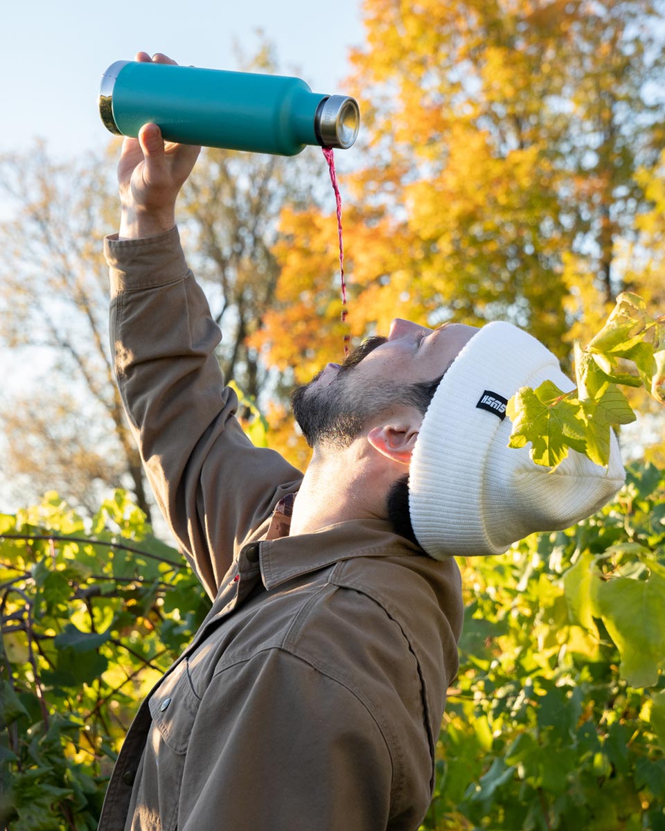 Man tipping his head back and pouring liquid from a Klean kanteen stainless steel pour through bottle into his mouth