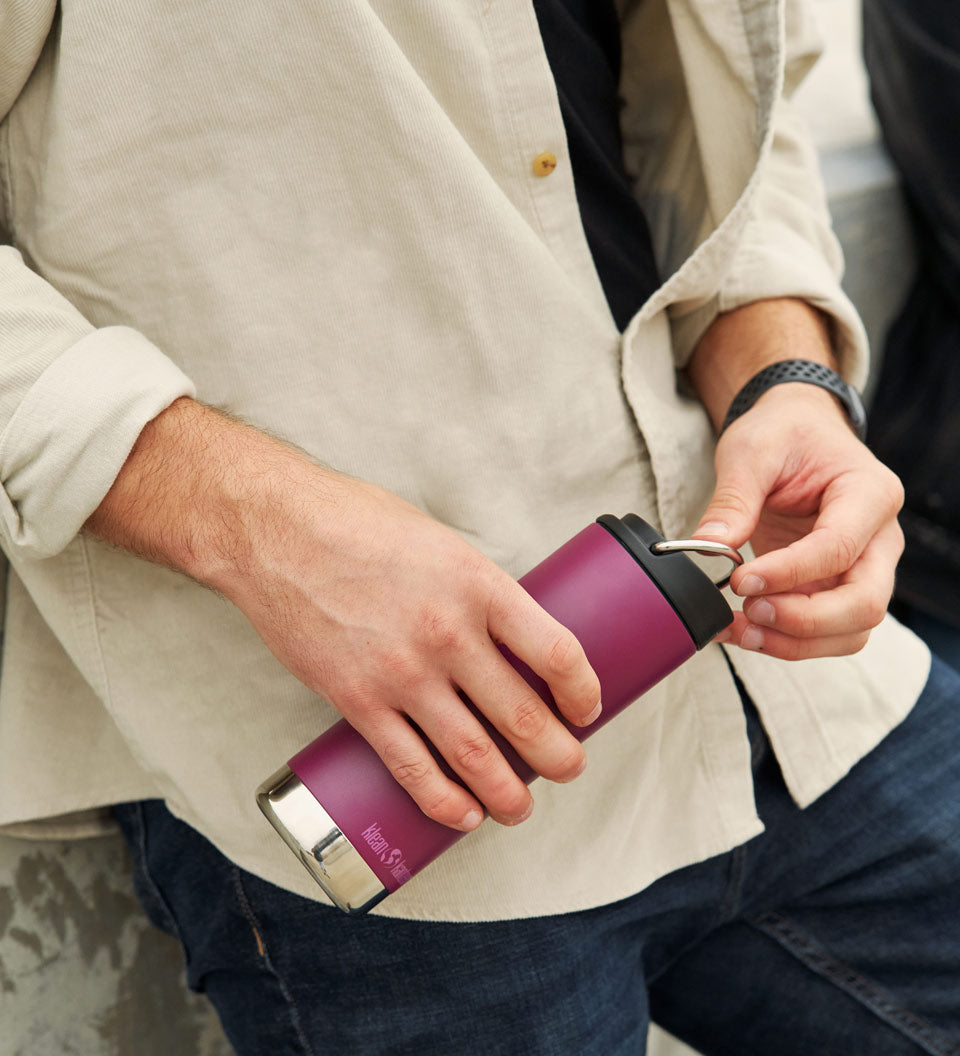 Close up of man holding the Klean Kanteen 16oz tkwide reusable metal bottle 