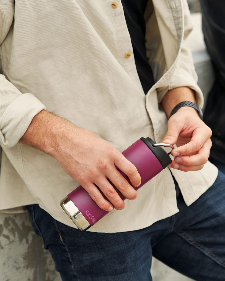 Close up of man holding the Klean Kanteen 16oz tkwide reusable metal bottle 