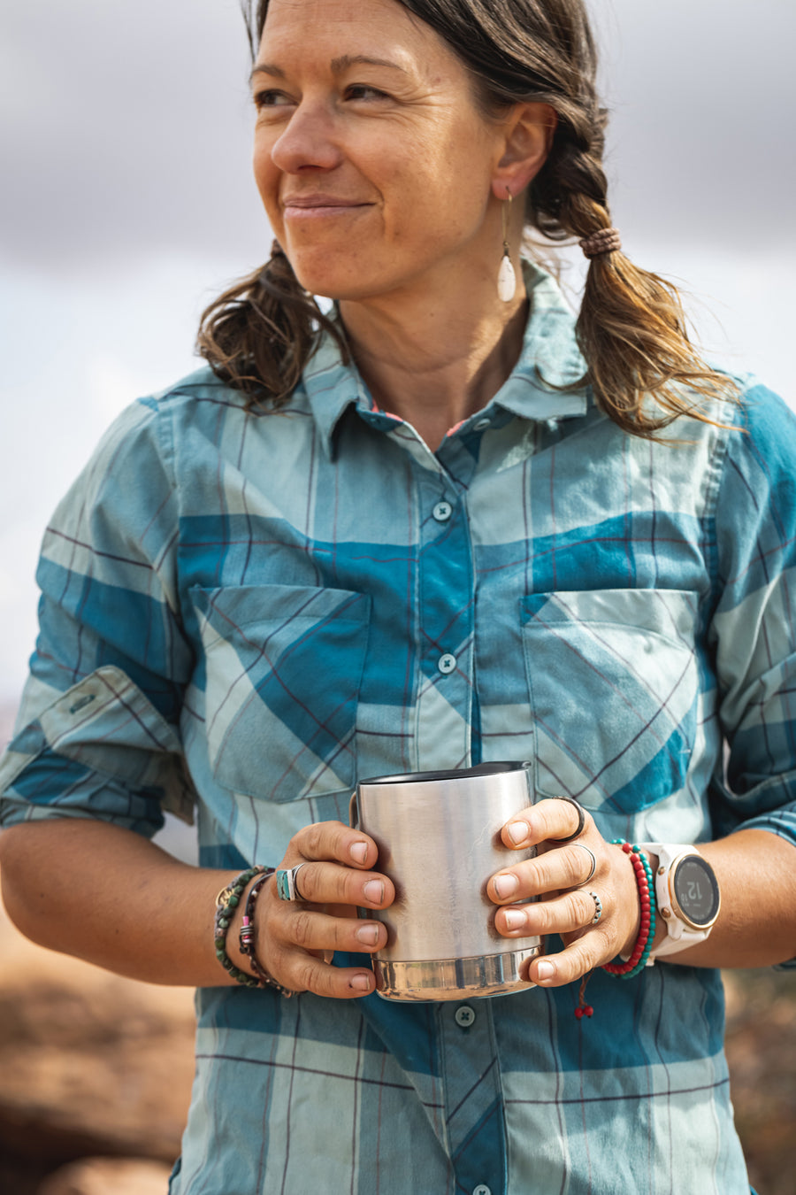 An adult holding their Klean Kanteen 12oz Stainless Steel Camping Mug in their hands