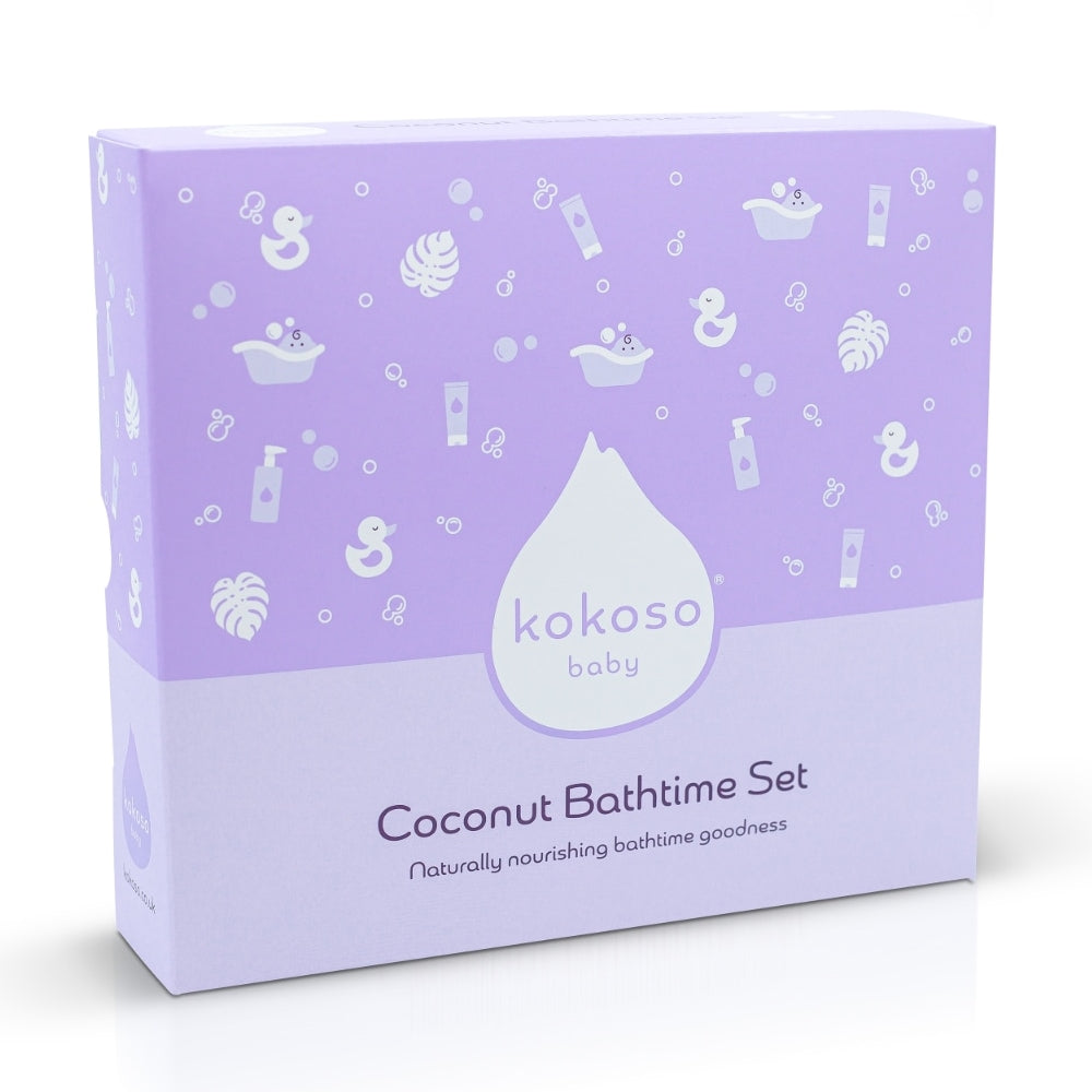 The reverse of the Kokoso Coconut Bathtime Organic Baby Gift Set in its purple and white gift box sitting on a backdrop of large Green leaves. The words Clean