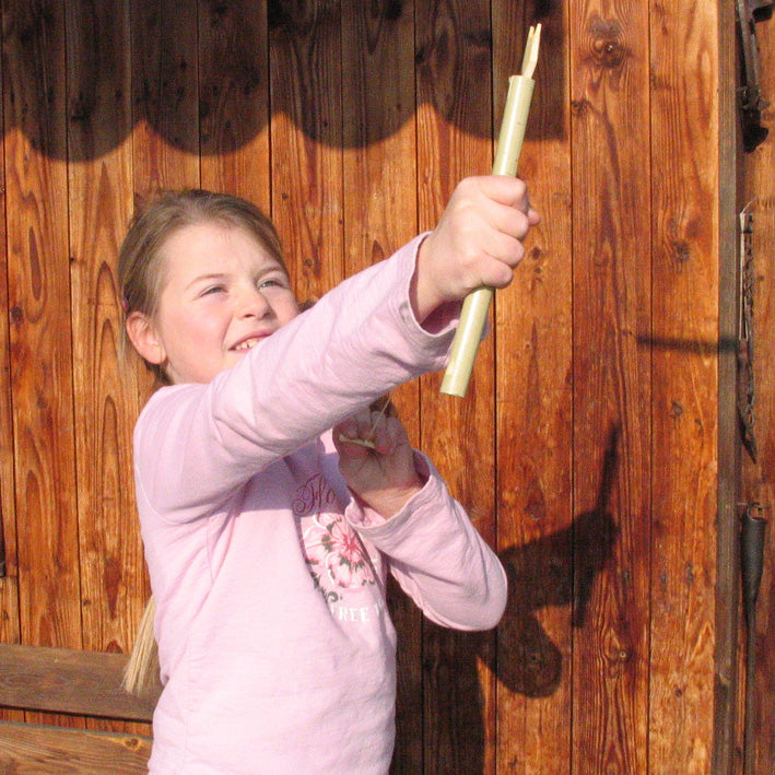 Child demonstrating how to use the Kraul Super Bamboo Dragonfly.