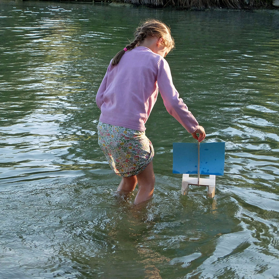 Child playing outside in the water