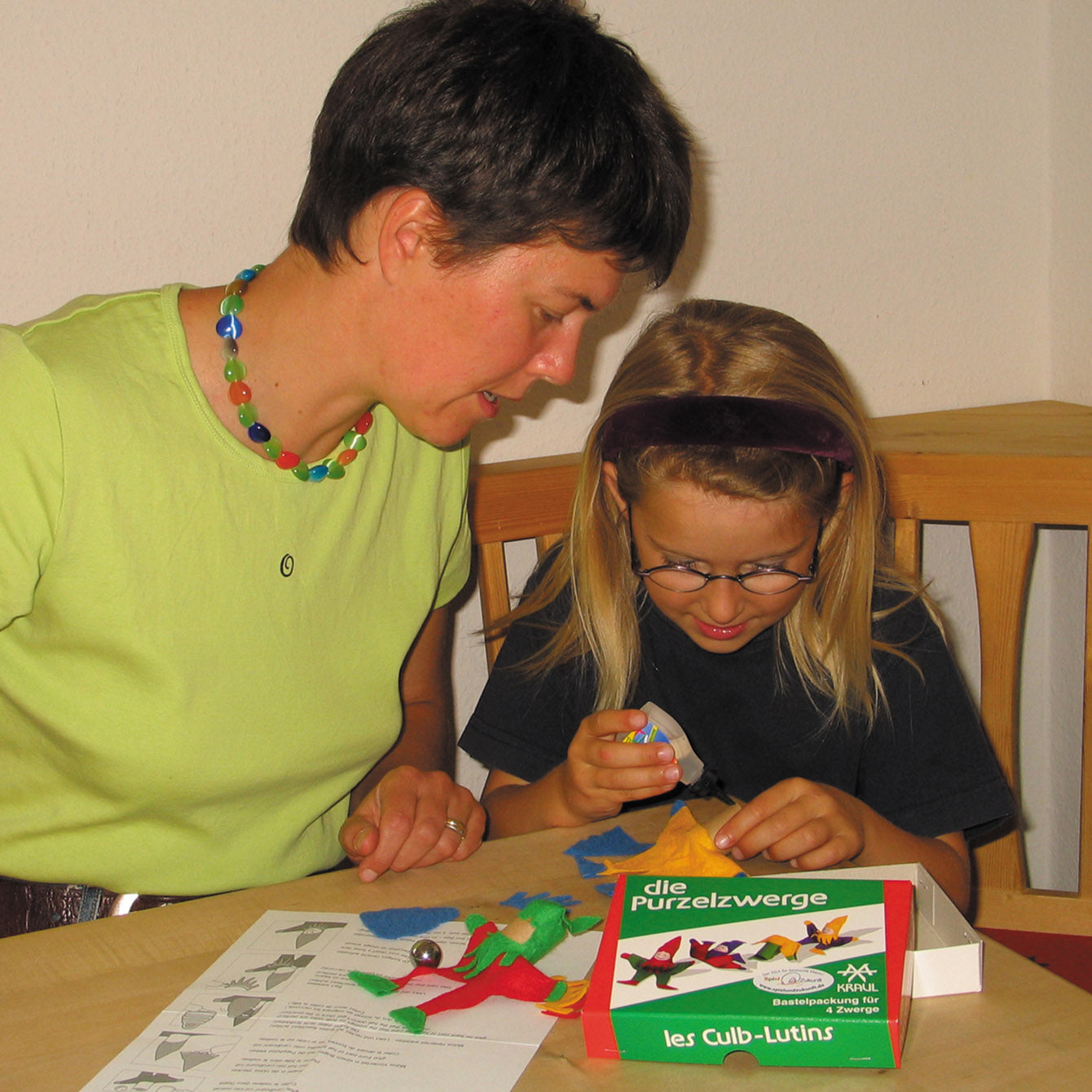 Child and adult demonstrating how to make the Kraul Tumbling Gnomes.