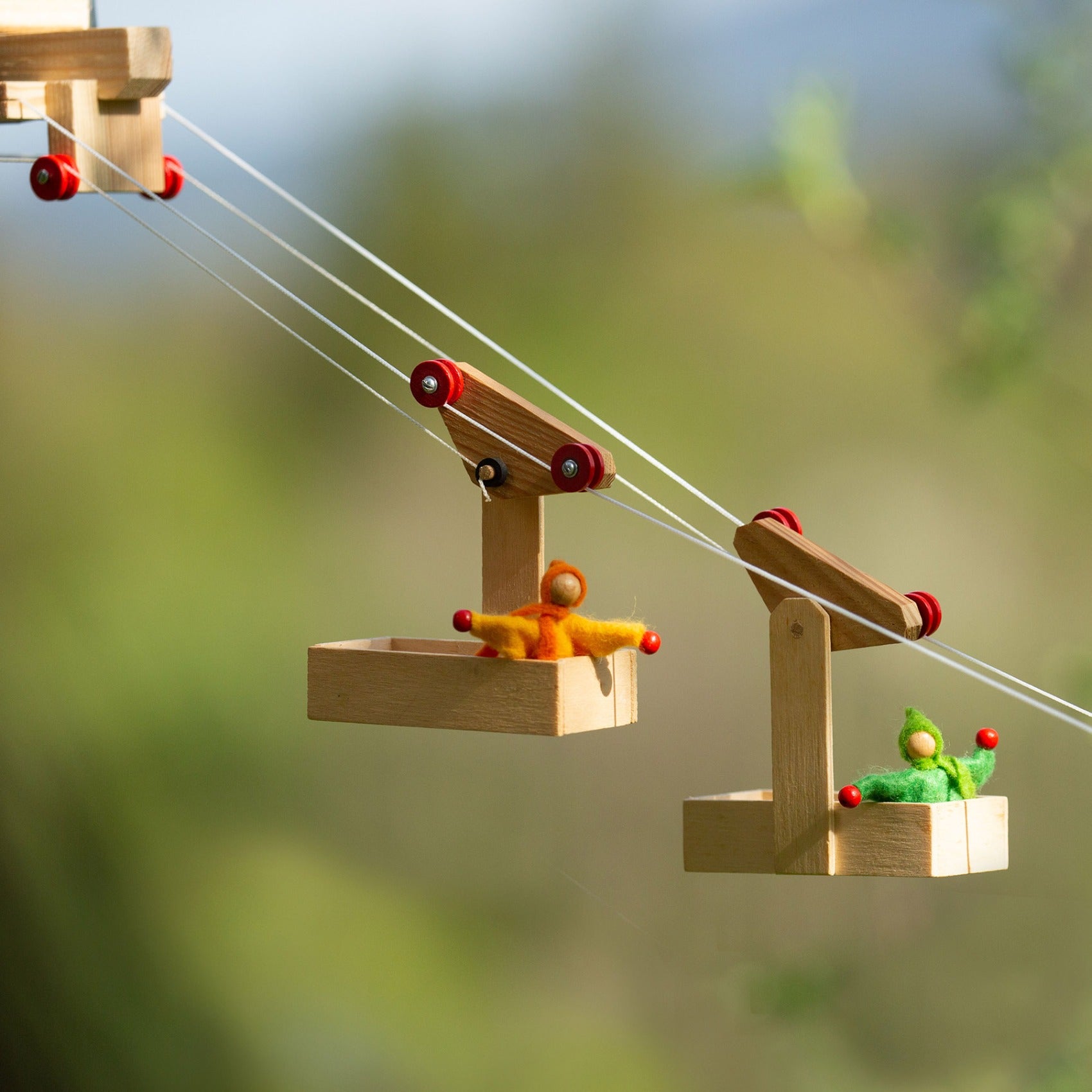 The Kraul Mini Cable Car Set with two Gondolas and a Sation. Both cars have a tiny doll inside.