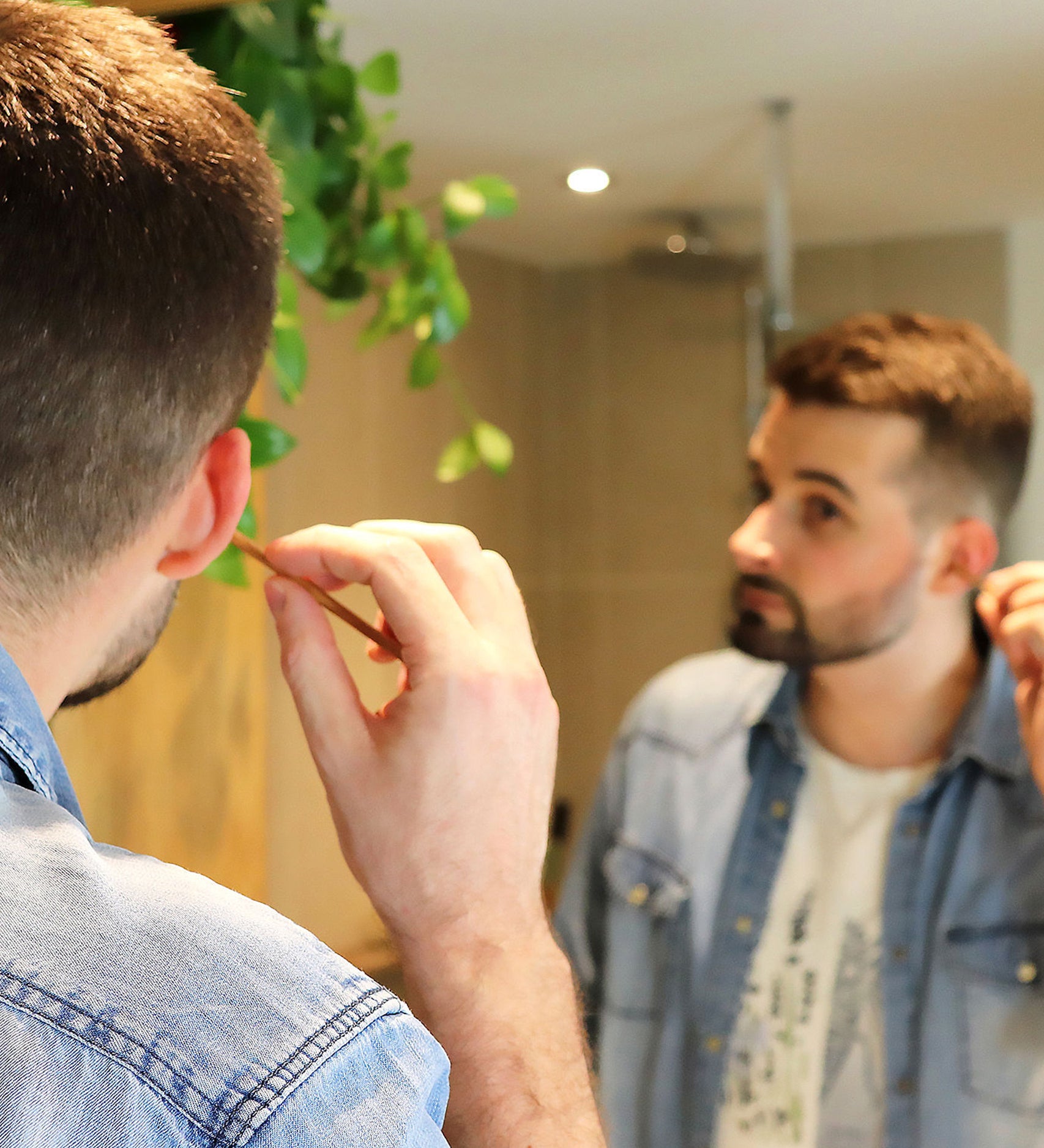 A person using the Lamazuna Wooden Bamboo Oriculi Ear Cleaning Stick