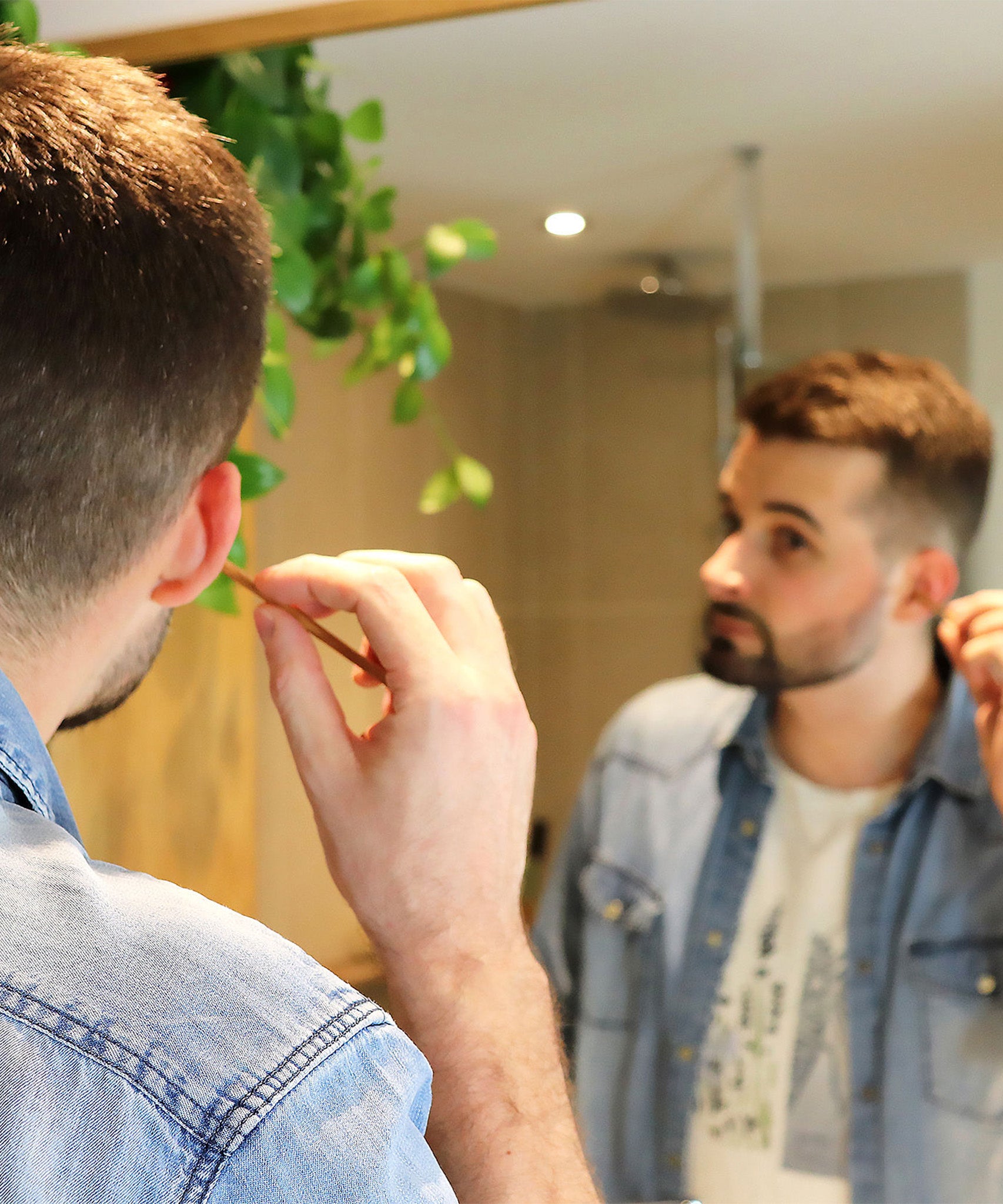 A person using the Lamazuna Wooden Bamboo Oriculi Ear Cleaning Stick