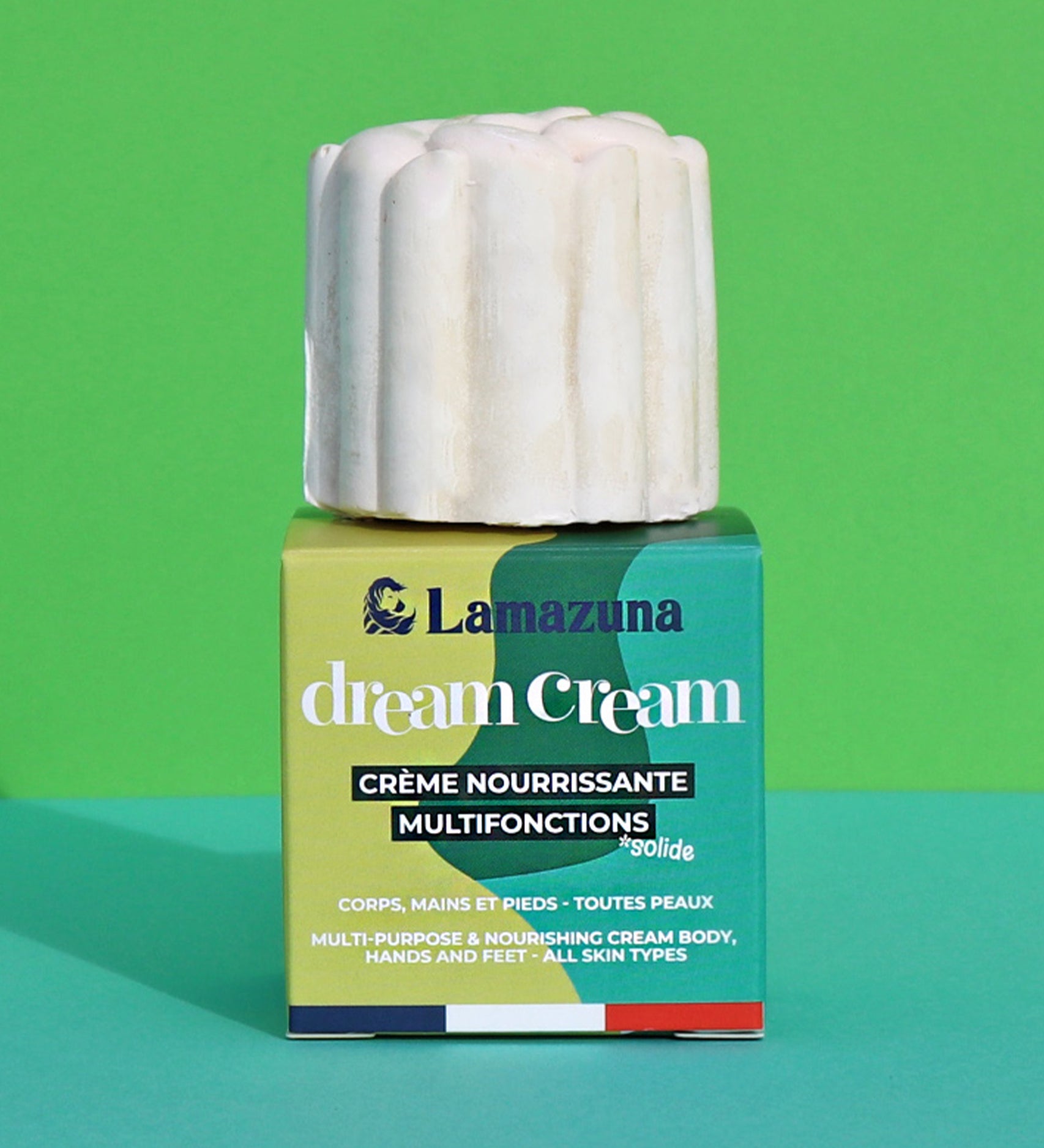 Lamazuna Nourishing Dream Cream Bar, sat on top of its box on a green background