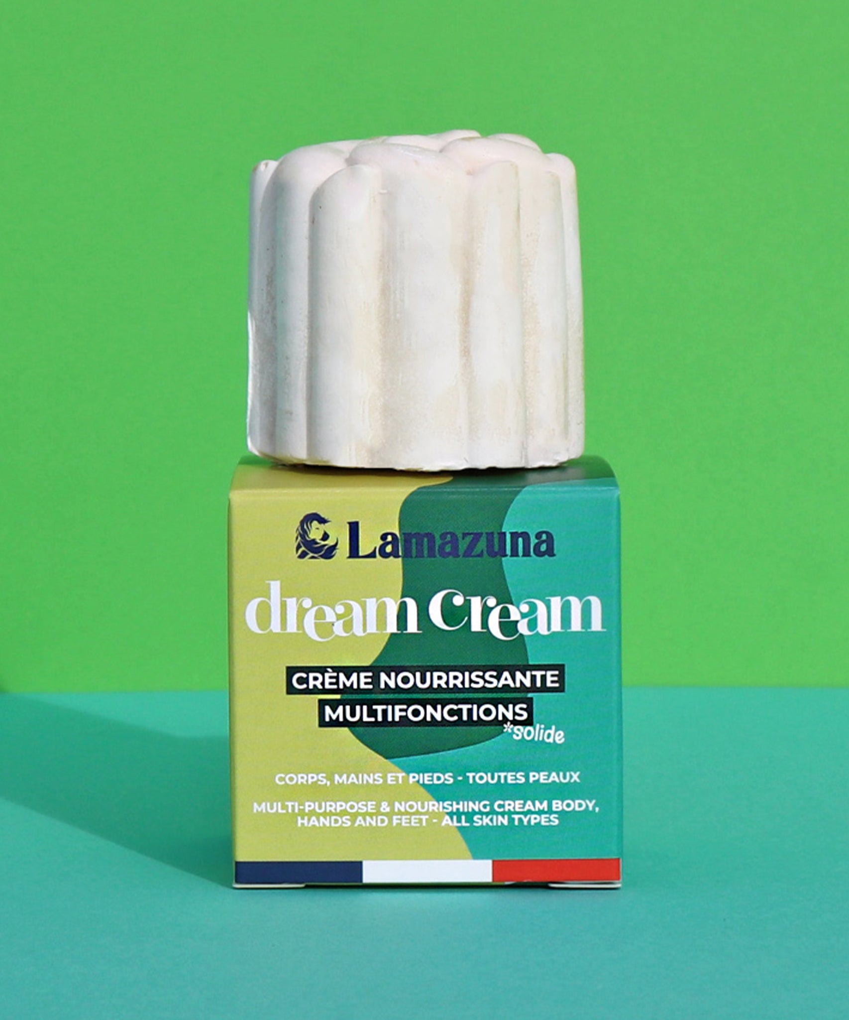 Lamazuna Nourishing Dream Cream Bar, sat on top of its box on a green background