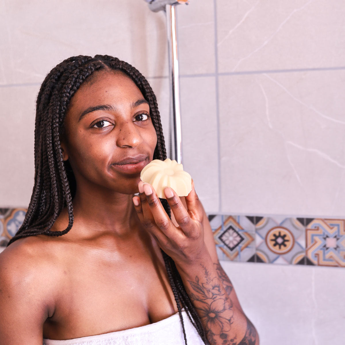 Person holding and sniffing the Lamazuna Detangling & Nourishing Solid Conditioner Bar