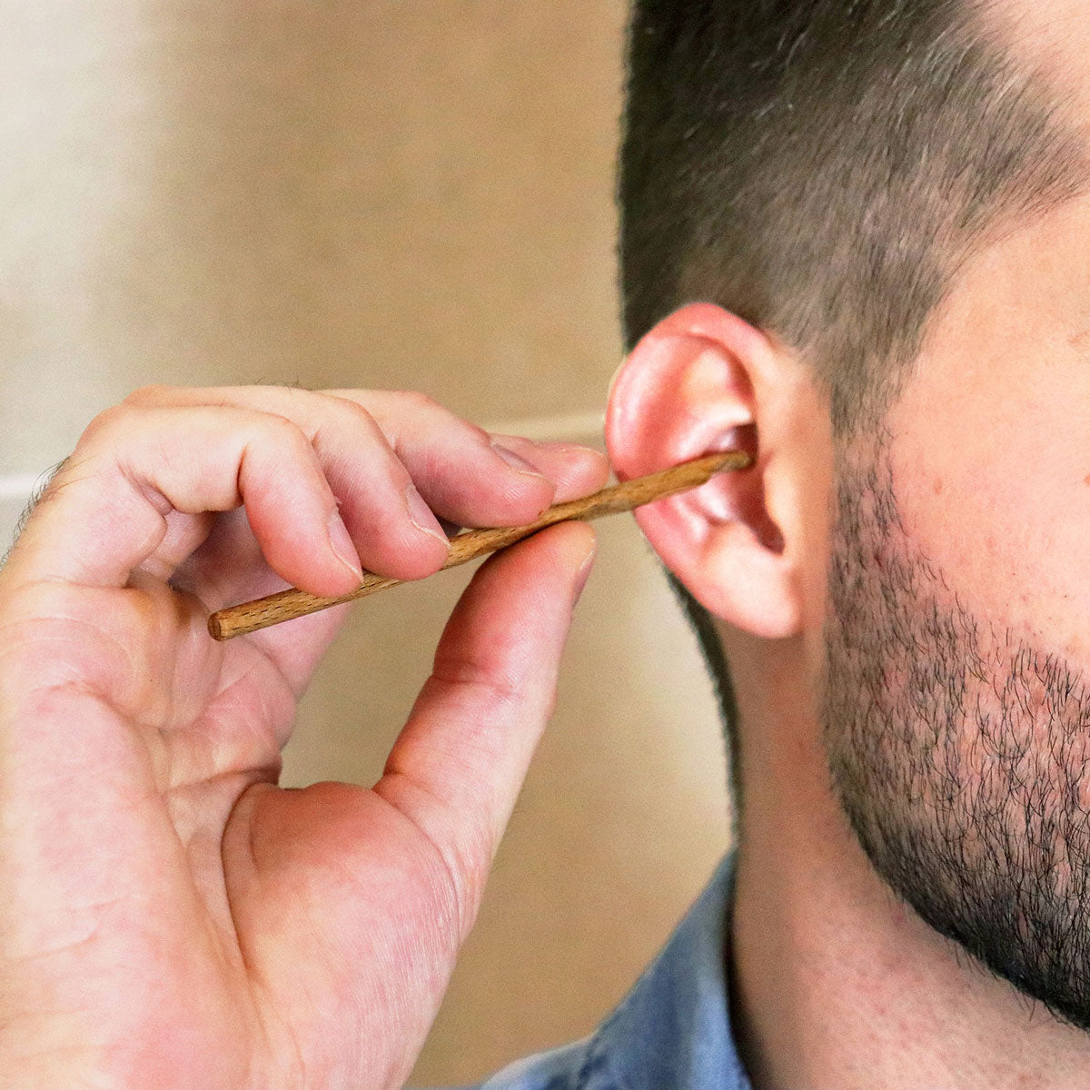 person using the Lamazuna Wooden Oriculi Ear Swab