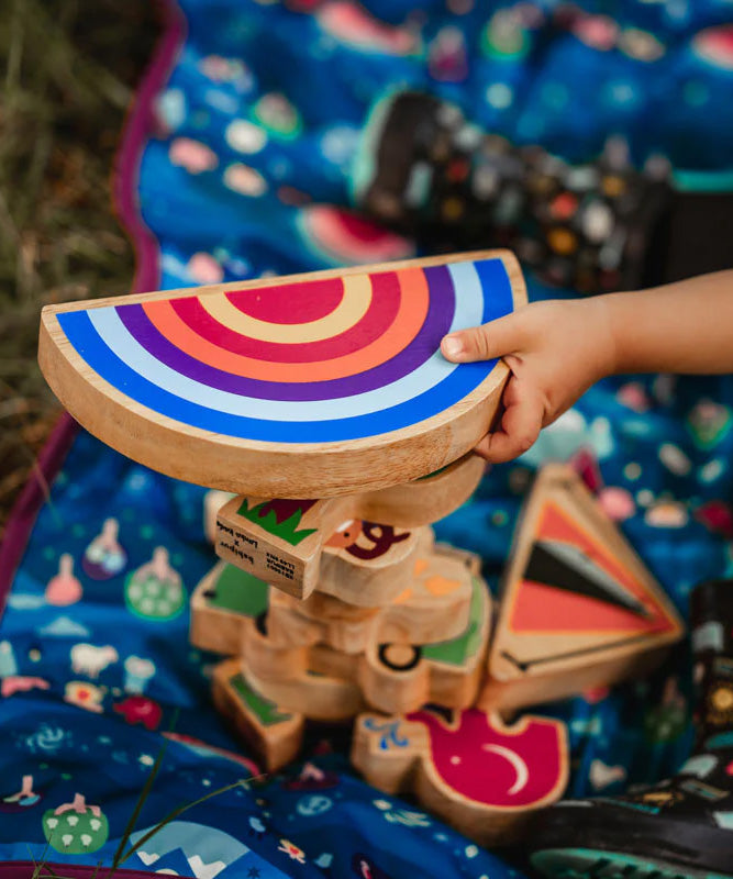 A close up of hand grabbing the Lanka Kade Babipur Machlud Haul Sunset toy on top of a stack of Lanka Kade dan y ser figures.