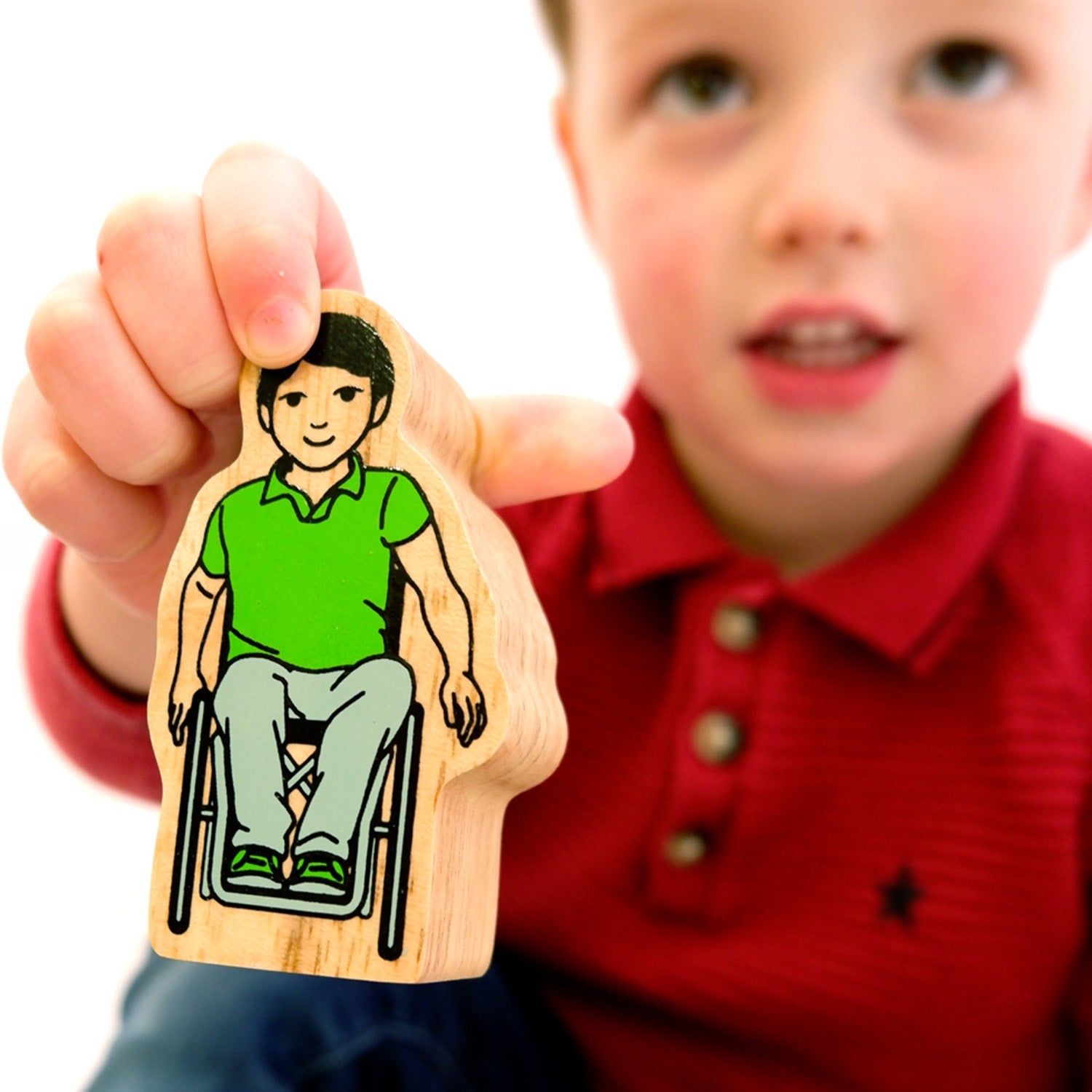 A child plays with a figure from the Lanka Kade Community Playset.