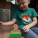 Boy sat playing with the Lanka Kade Babipur lola campervan wooden toy on a wooden surface