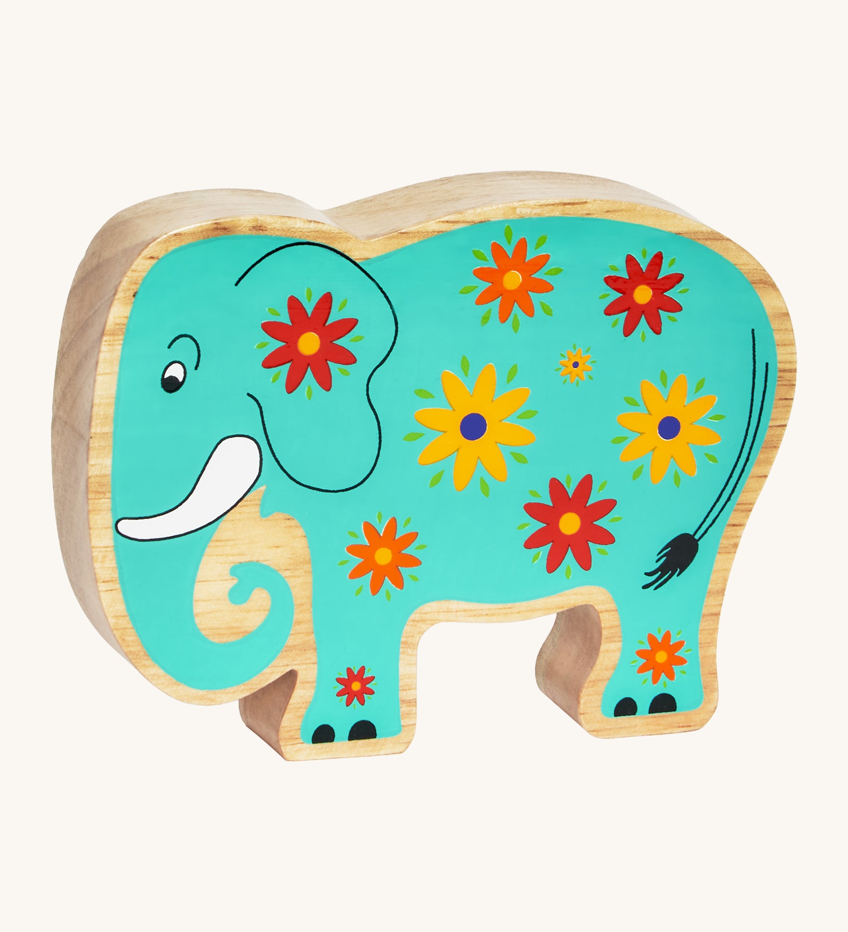 A green wooden Lanka Kade elephant with yellow and red flowers on a cream background.