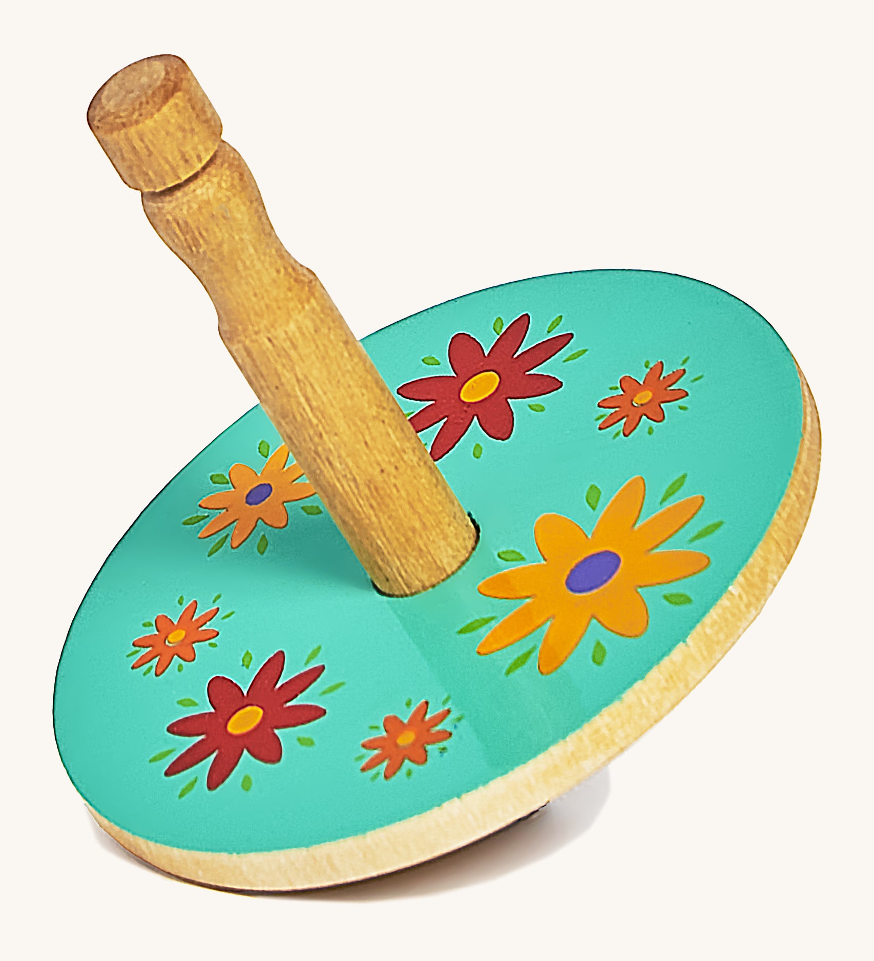 A green wooden Lanka Kade spinning top with red and yellow flowers on a cream background.