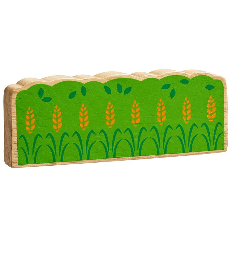 Lanka Kade green wooden hedge toy on a plain background. The hedge is green with darker green leaf details and yellow wheat. 