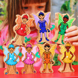 Close up of a child playing with the Lanka Kade plastic-free Waldorf fairy figures on a red table