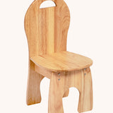 Lanka Kade Wooden Child's Chair. The chair is made from rubber wood and has a rounded seat and rounded high back design with a cut our handle.