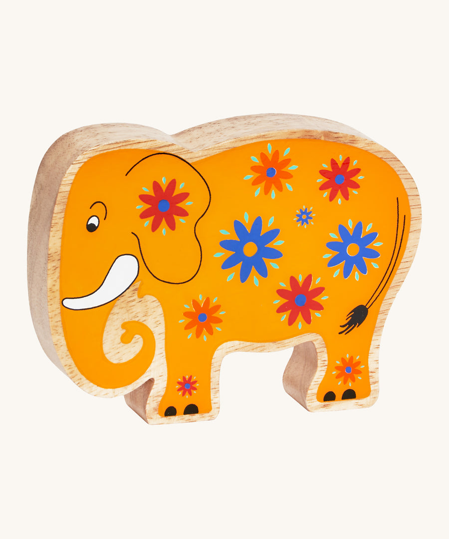 A yellow wooden Lanka Kade elephant with blue and red flowers on a cream background.