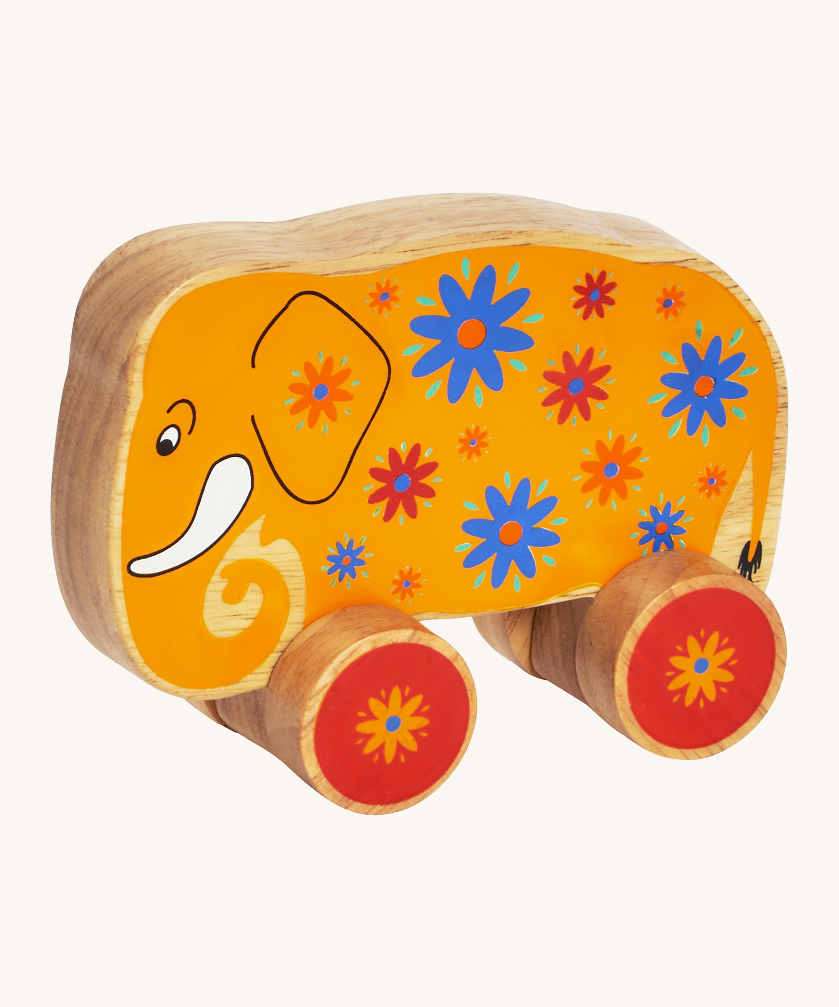 A yellow wooden Lanka Kade push along elephant with blue and red flowers with red wheels on a cream background.