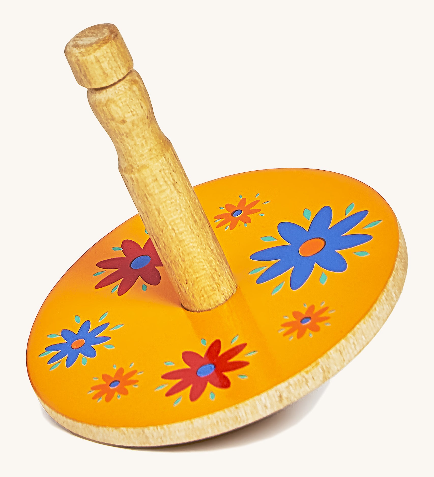 A yellow wooden Lanka Kade spinning top with red and blue flowers on a cream background.