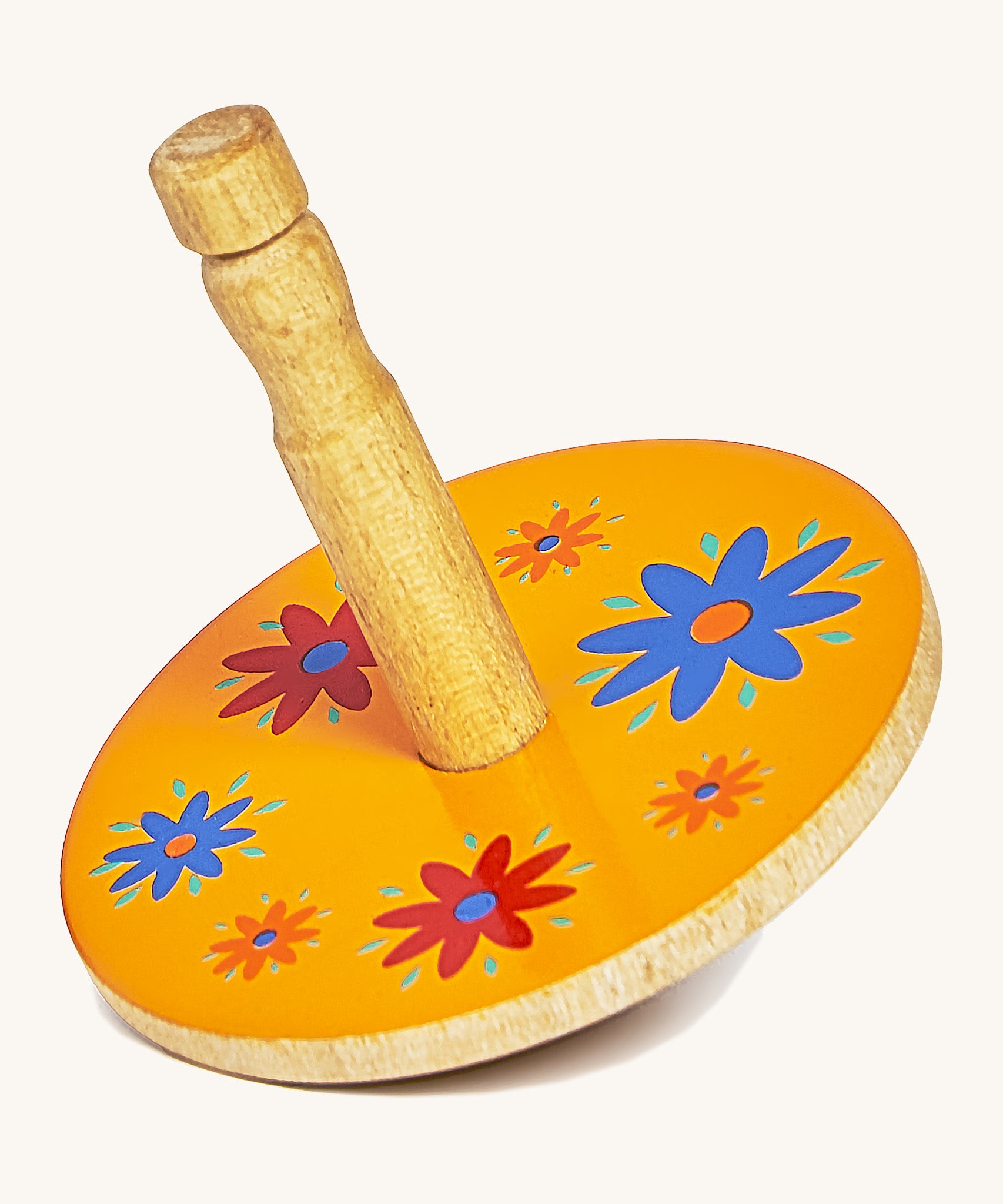 A yellow wooden Lanka Kade spinning top with red and blue flowers on a cream background.