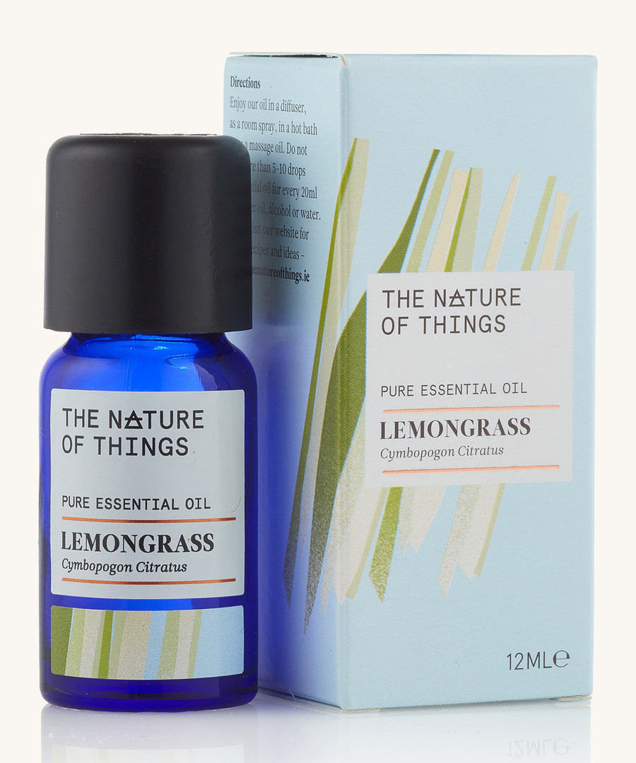 Lemongrass pure essential oil in a blue glass bottle in front of a decorative blue cardboard box.