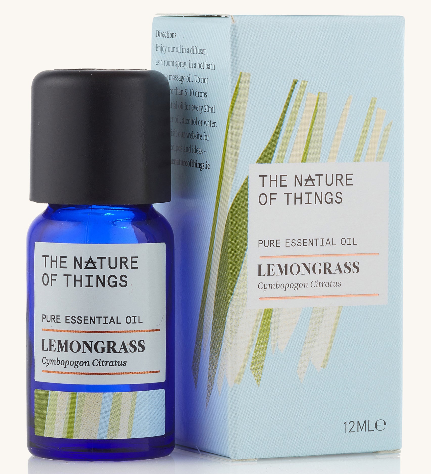 Lemongrass pure essential oil in a blue glass bottle in front of a decorative blue cardboard box.