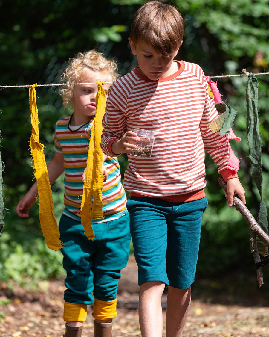  they comfy blue shorts have two pockets and an orange drawstring cord in the waistband