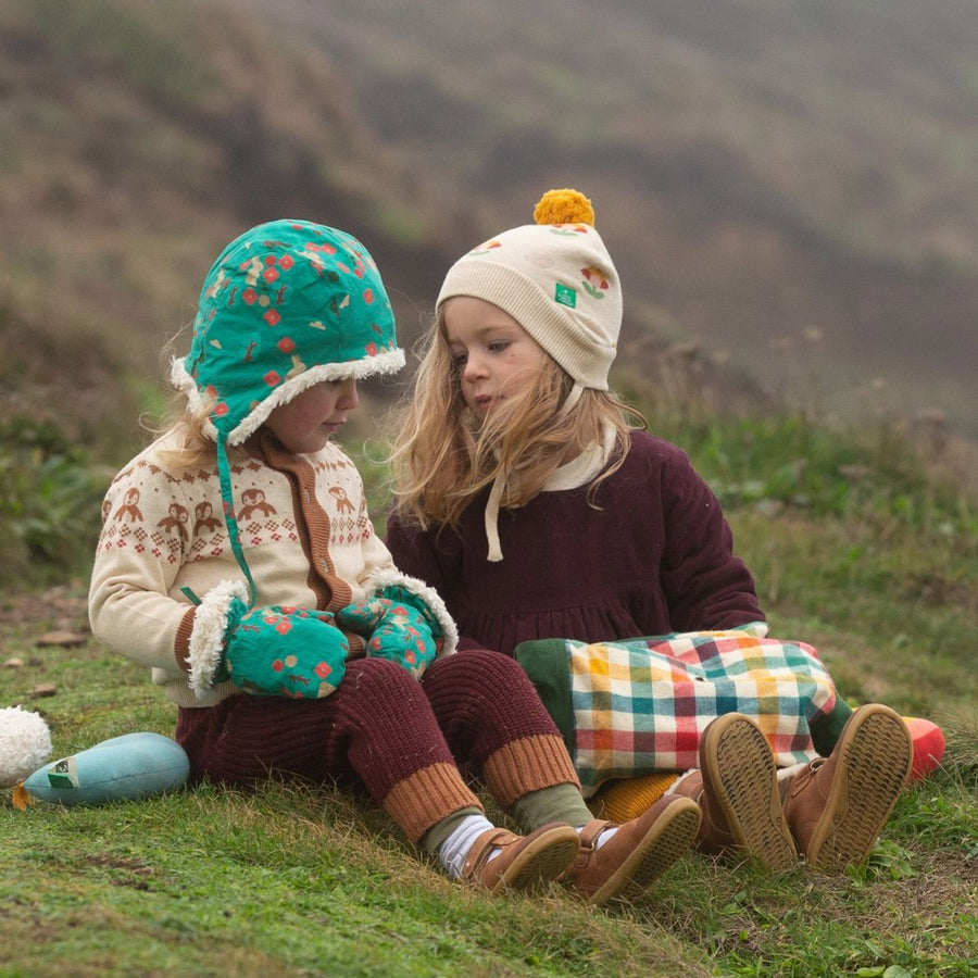 Two children sit outdoors