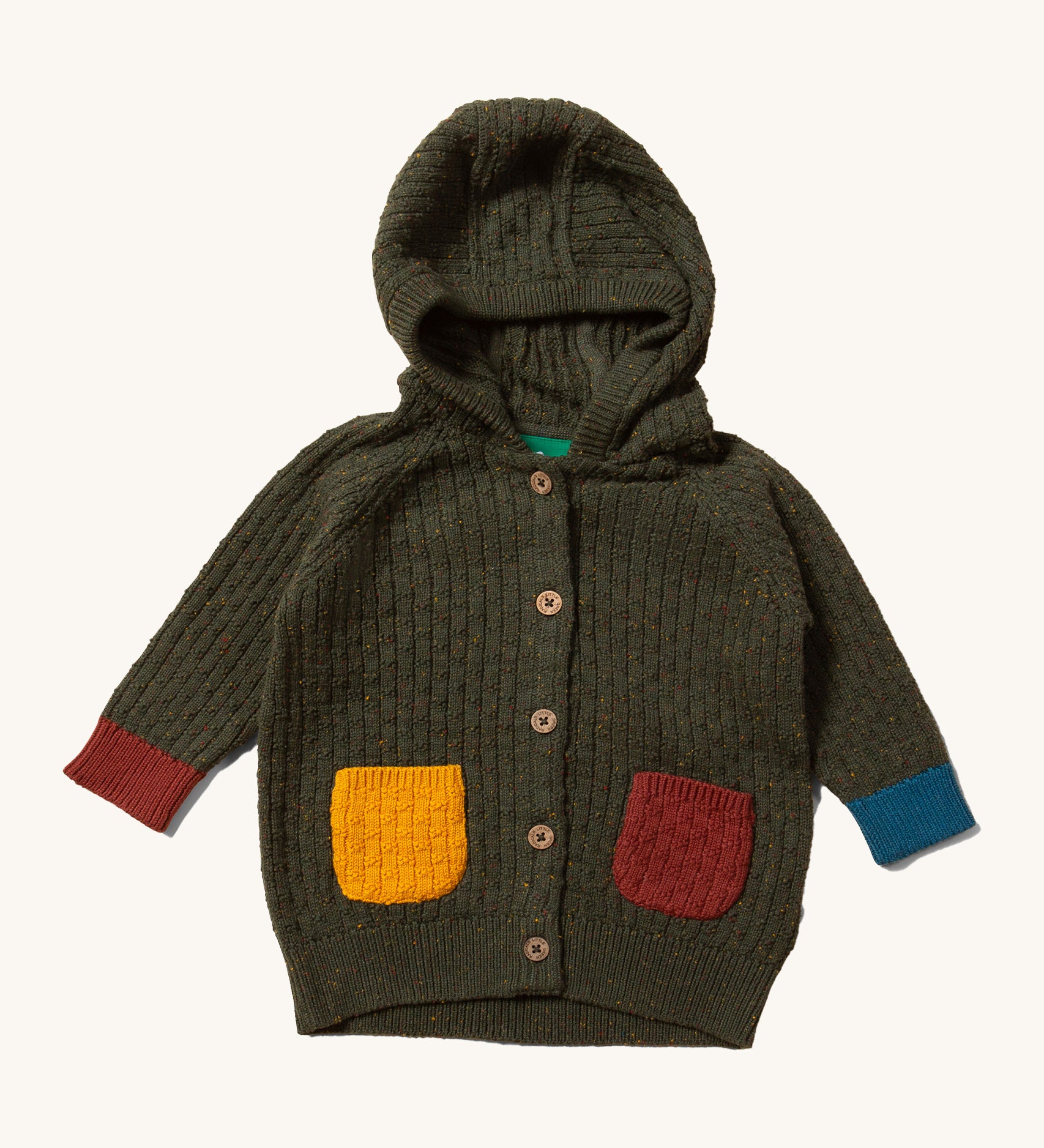 Little Green Radicals kids fern green knitted hooded cardigan with yellow and red pockets on a cream background.