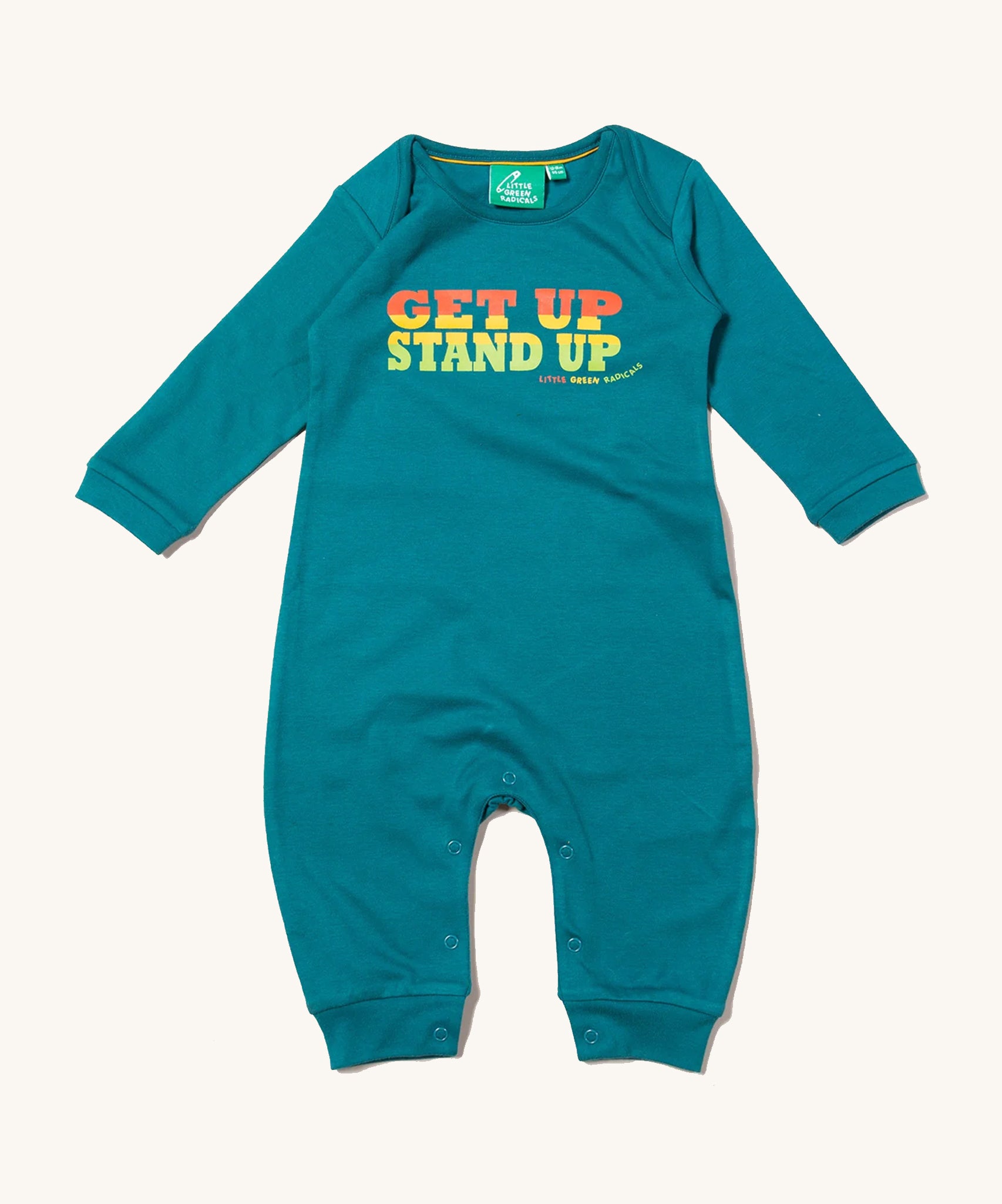 Little Green Radicals Get Up Stand Up Organic Cotton Playsuit in a turquoise coloured fabric, with orange, yellow and green lettering on a cream background