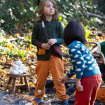 Little Green Radicals kids fern green knitted hooded cardigan with yellow and red pockets worn by a child