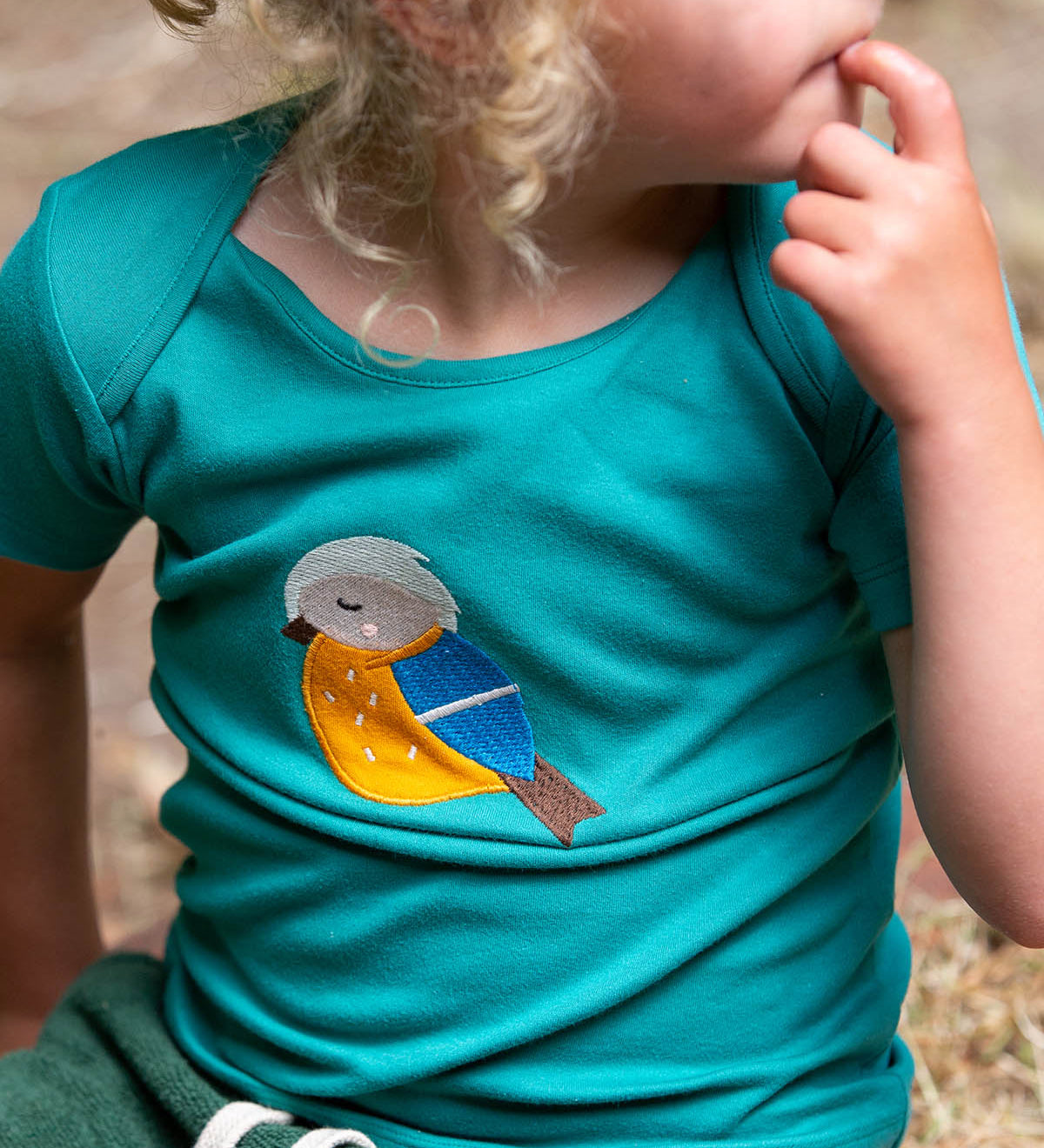  a beautiful green t-shirt with a sleepy bird applique which has a yellow belly