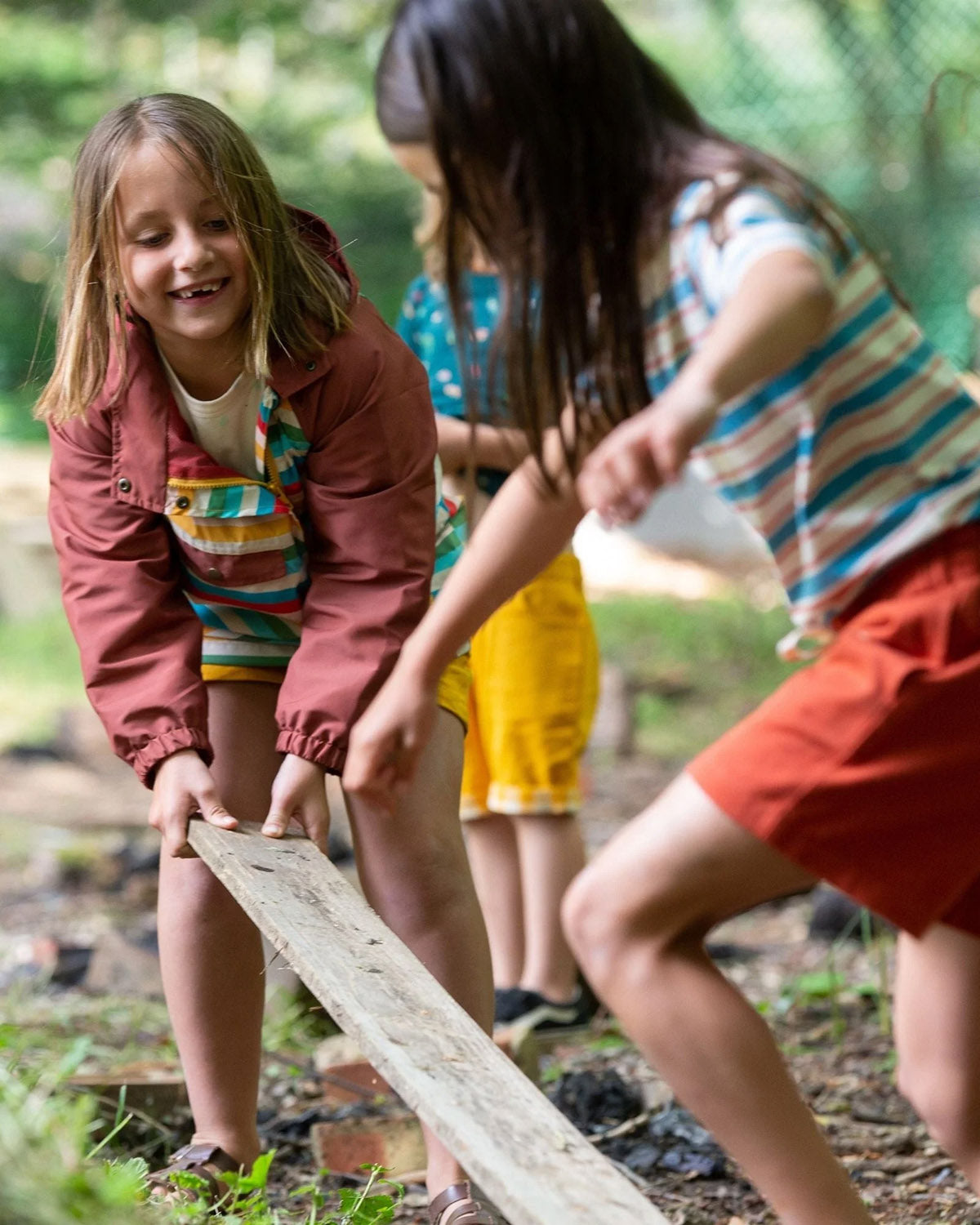  worn by a child playing with coloured fabric outside