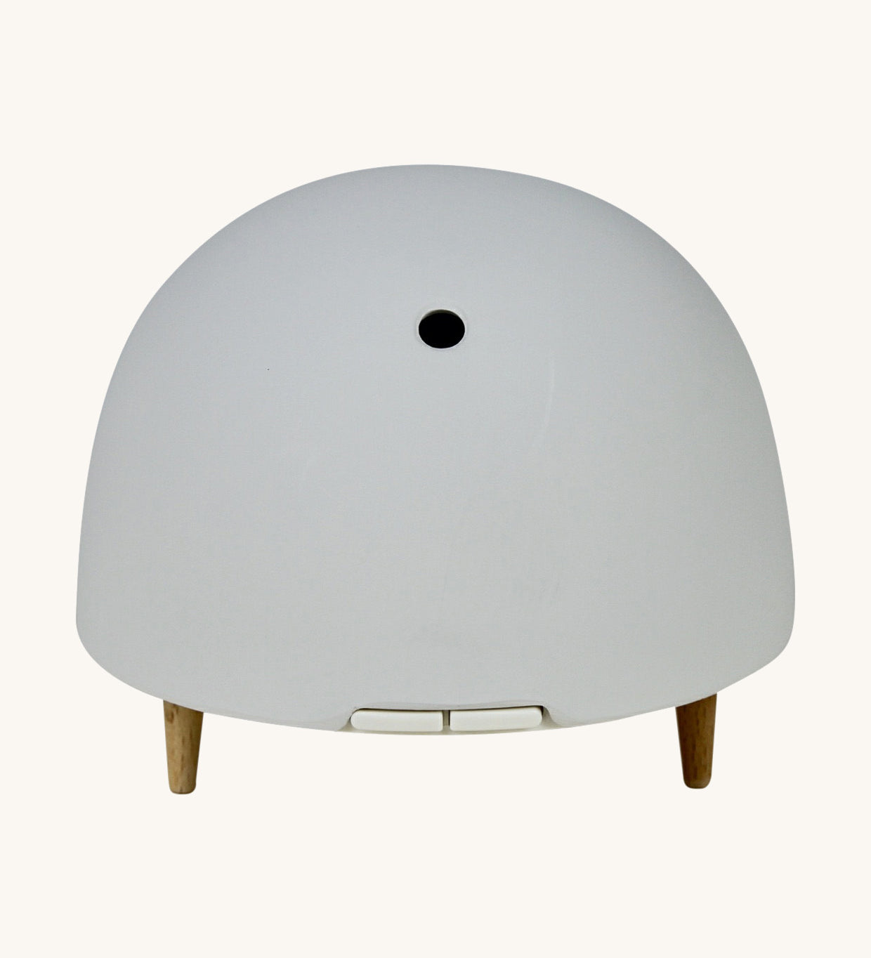 Maël Diffuser, a light grey dome plug-in essential oil diffuser with wooden feet. 