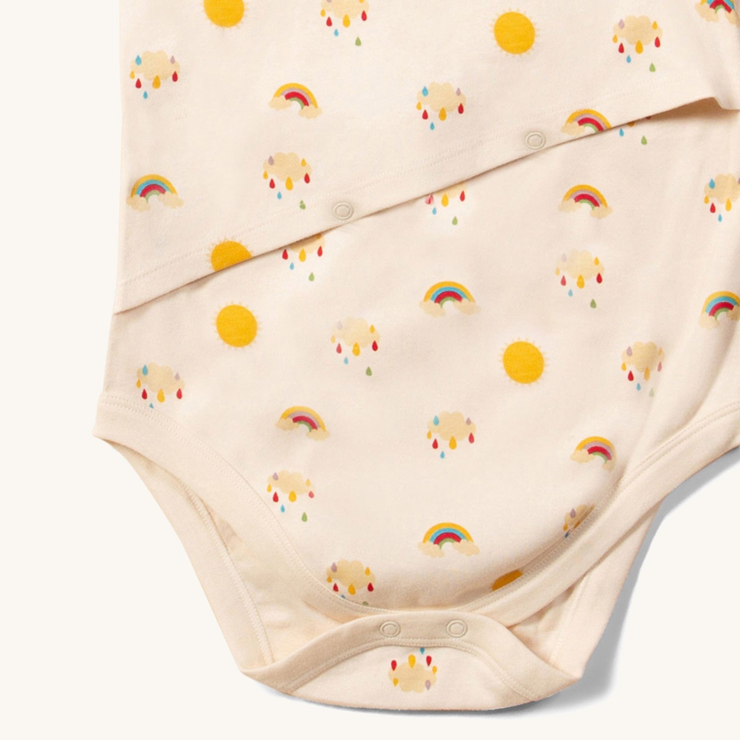 close up of the bottom of the Little Green Radicals Adaptive Easy Feeding Sunshine & Rainbows Bodysuit