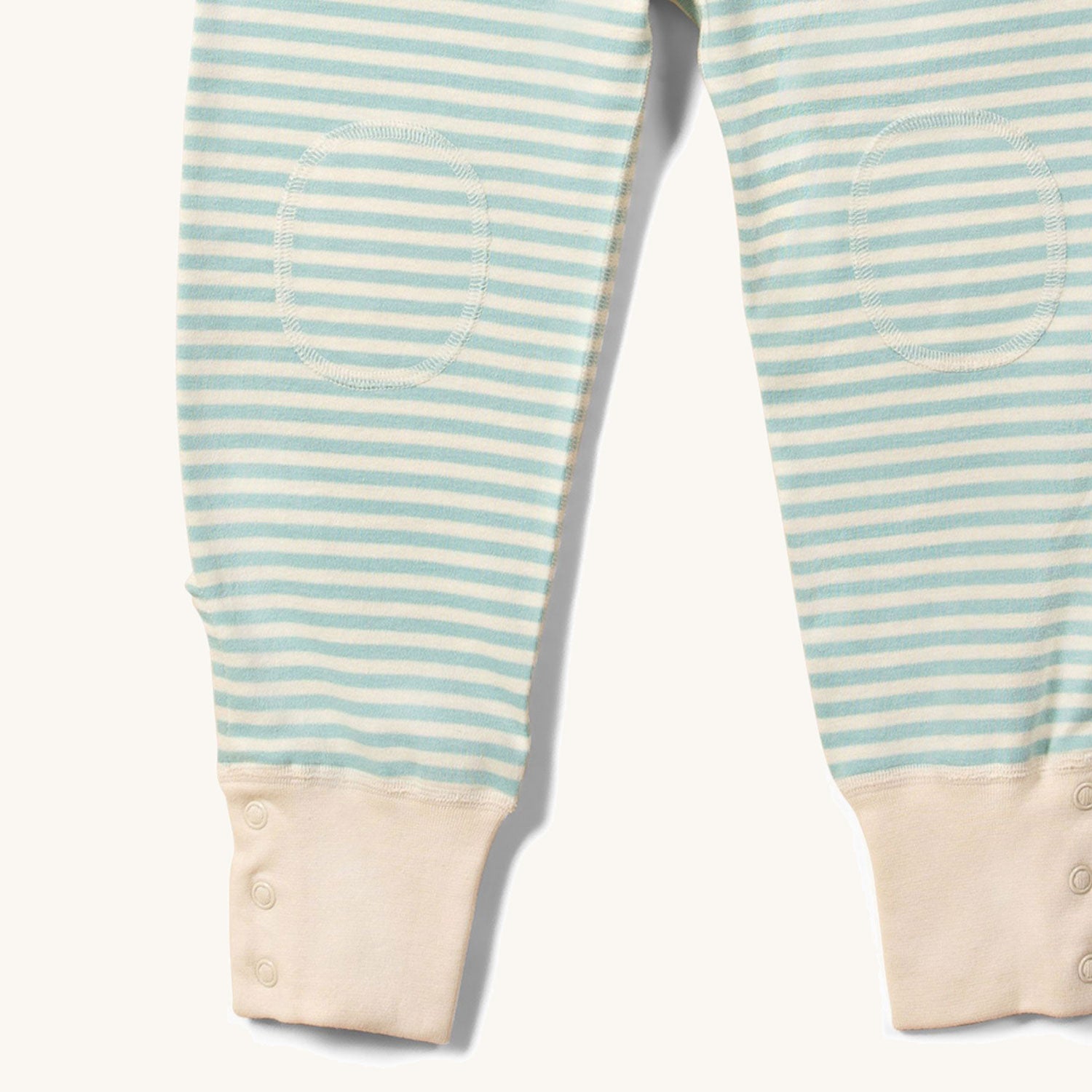 Close up of the knee patches on the Little Green Radicals Adaptive Extra Long Blue Striped Joggers pictured on a plain background