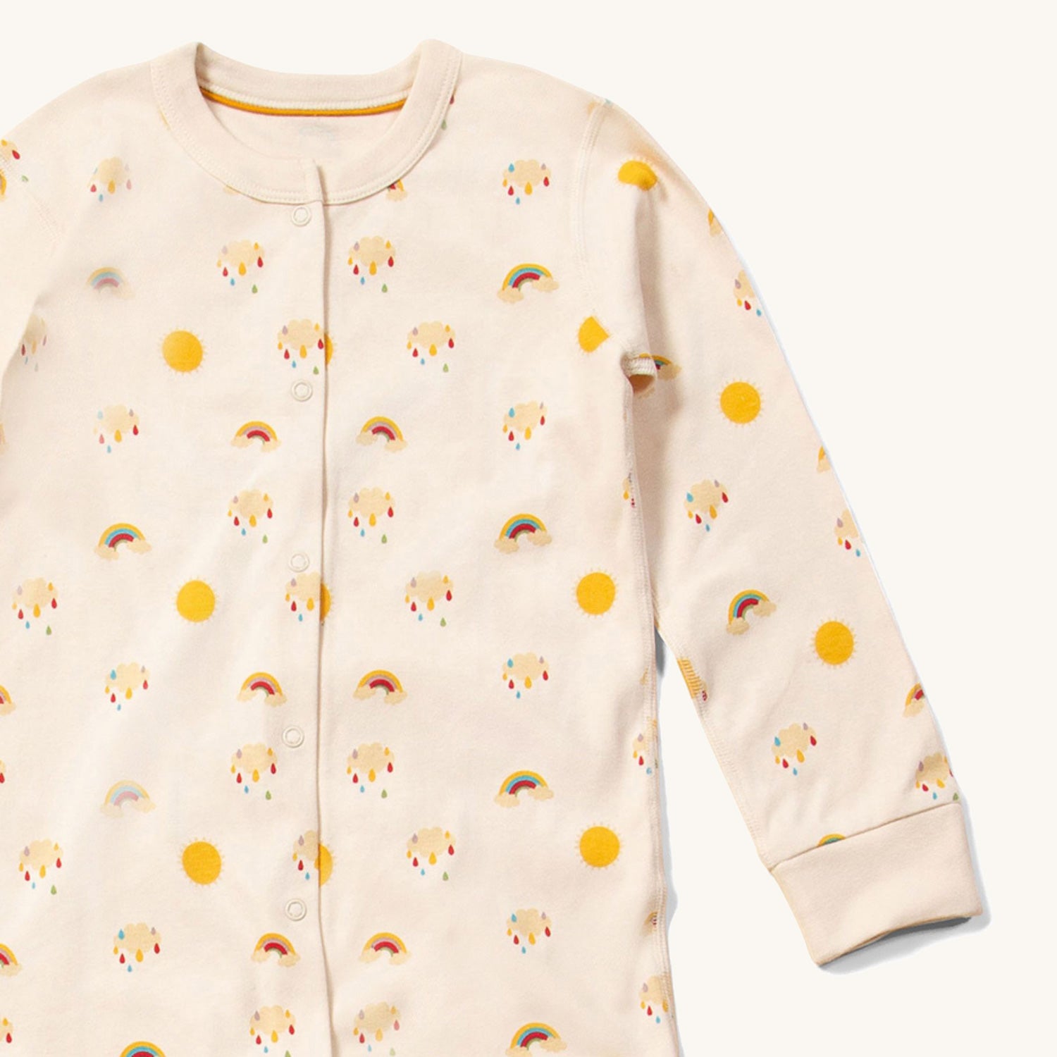 Close up of the front of the LGR Adaptive Sunshine & Rainbows Sleepsuit showing the popper closure