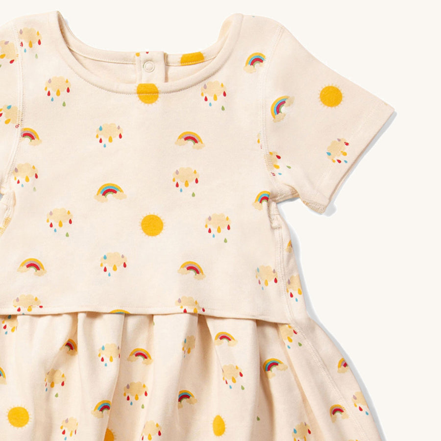 close up of the print f the Little Green Radicals Adaptive Sunshine & Rainbows Easy Peasy Dress pictured on a plain background