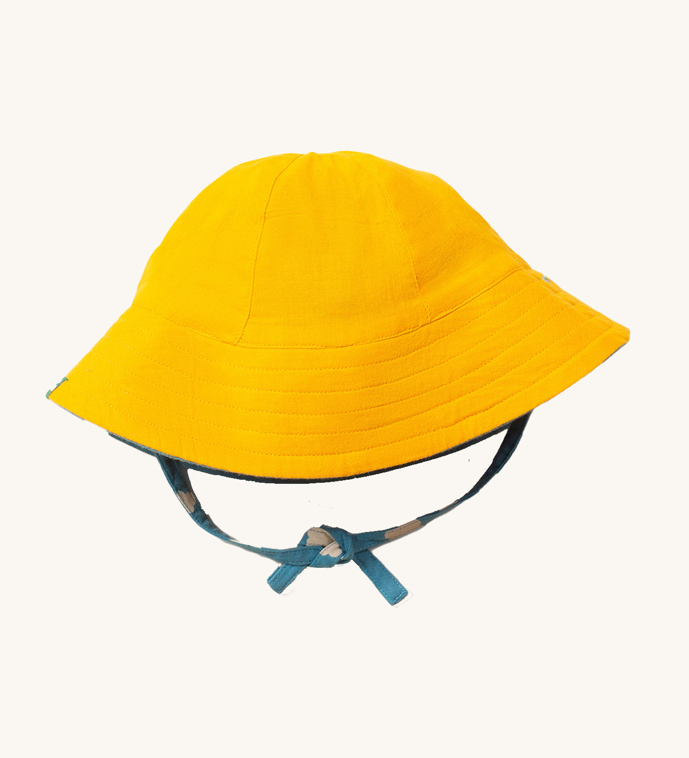 Little Green Radicals organic cotton Blue Clouds Reversible Baby Sun Hat, shown with the plain yellow side on the outside.