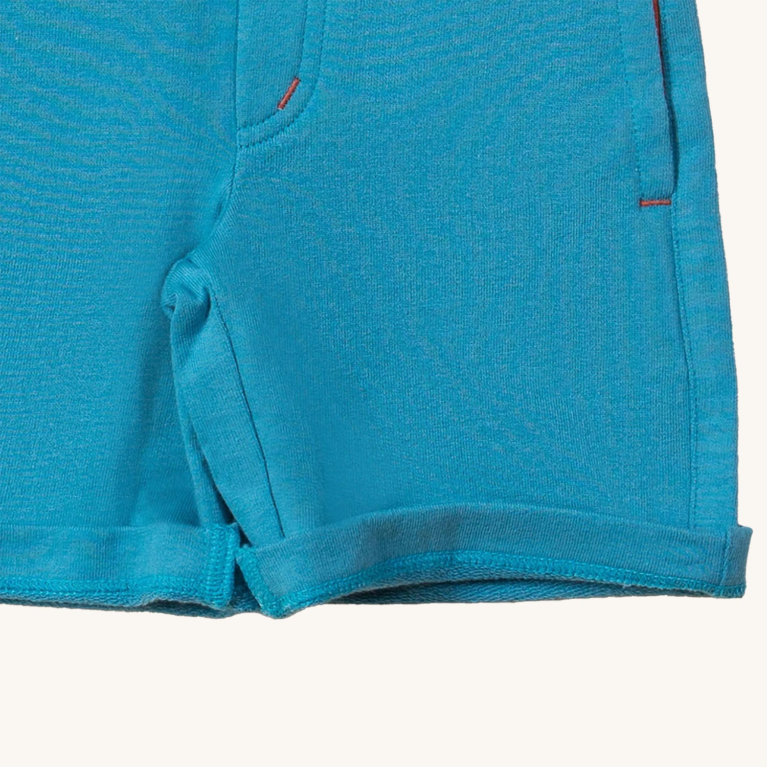  they comfy blue shorts have two pockets and an orange dra