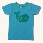 The Little Green Radicals Blue Whale Short Sleeve T-Shirt on a plain background. 