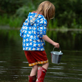 A child wearing the Little Green Radicals Diving And Splashing Blue Recycled Waterproof Kids Packable Anorak, facing away from the camera showing the back of the jacket.